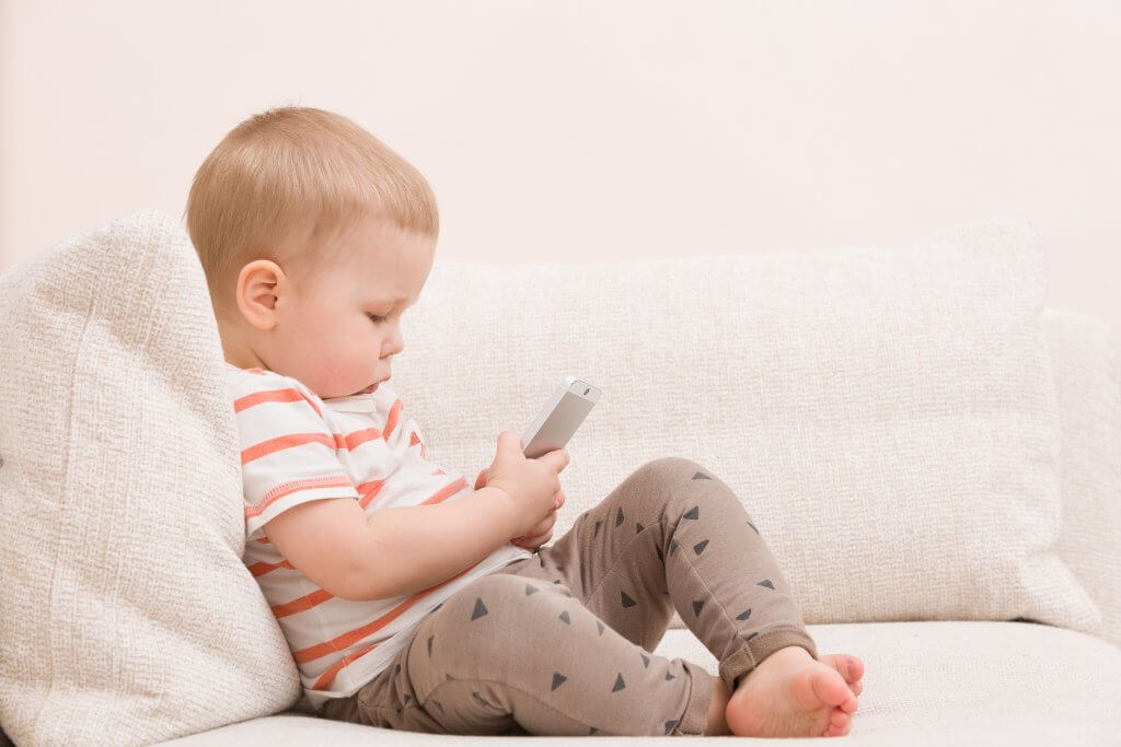 young child looking at phone screen