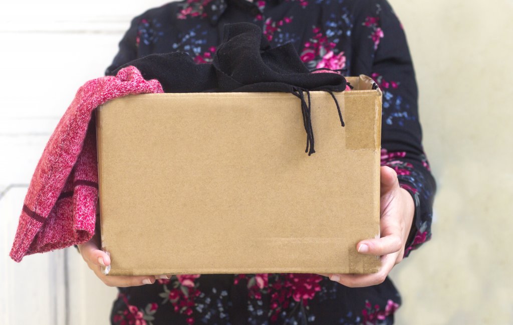 woman holding box of donations