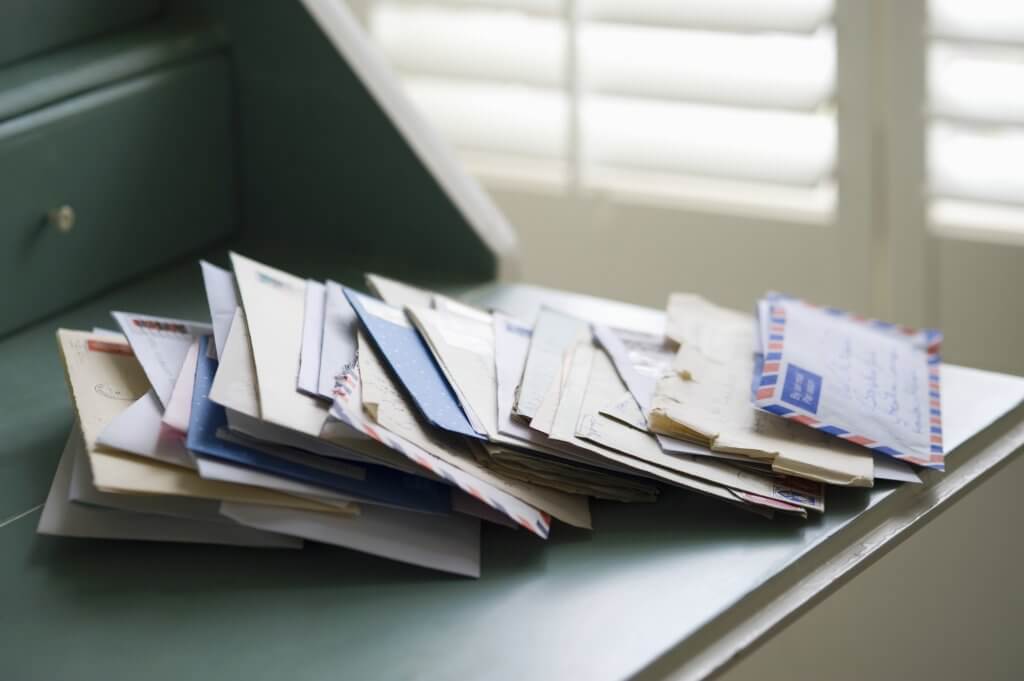 pile of mail on a desk