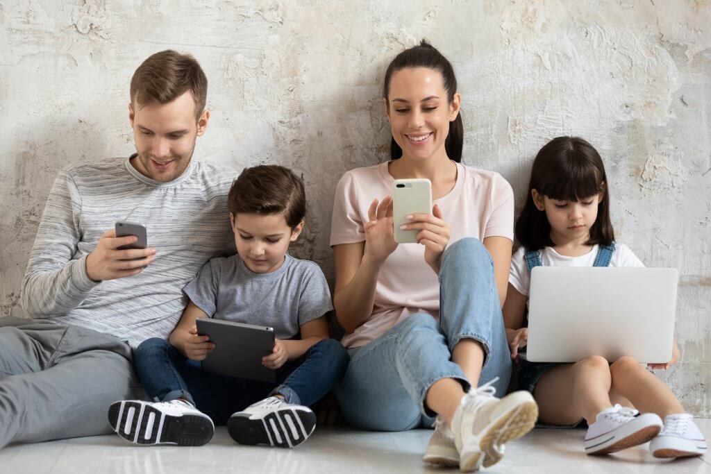 family members all looking at technology devices