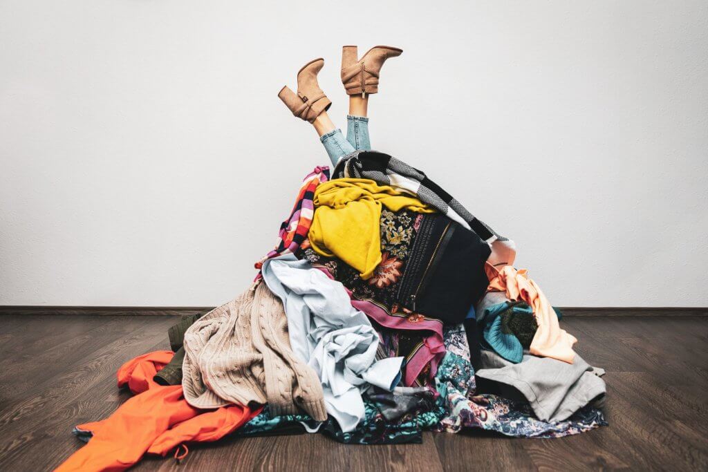 pile of clothes with feet at the top