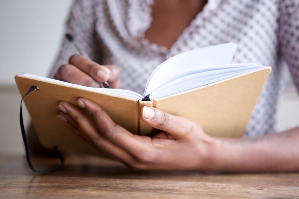 woman writing in a journal