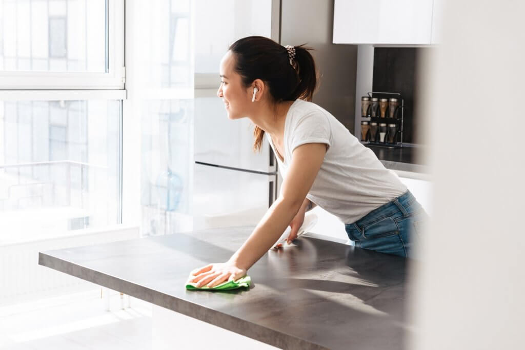 cleaning countertop with headphones