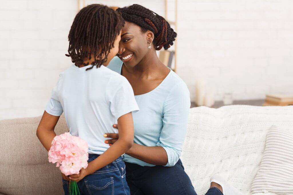 son giving mom flowers