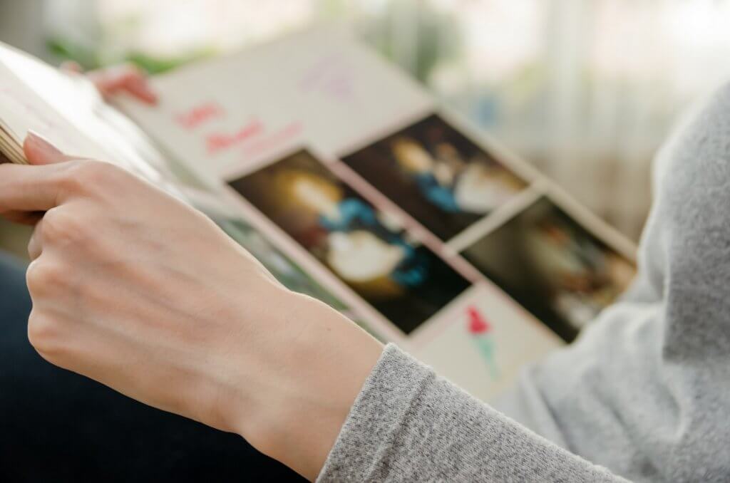 woman looking at photo album