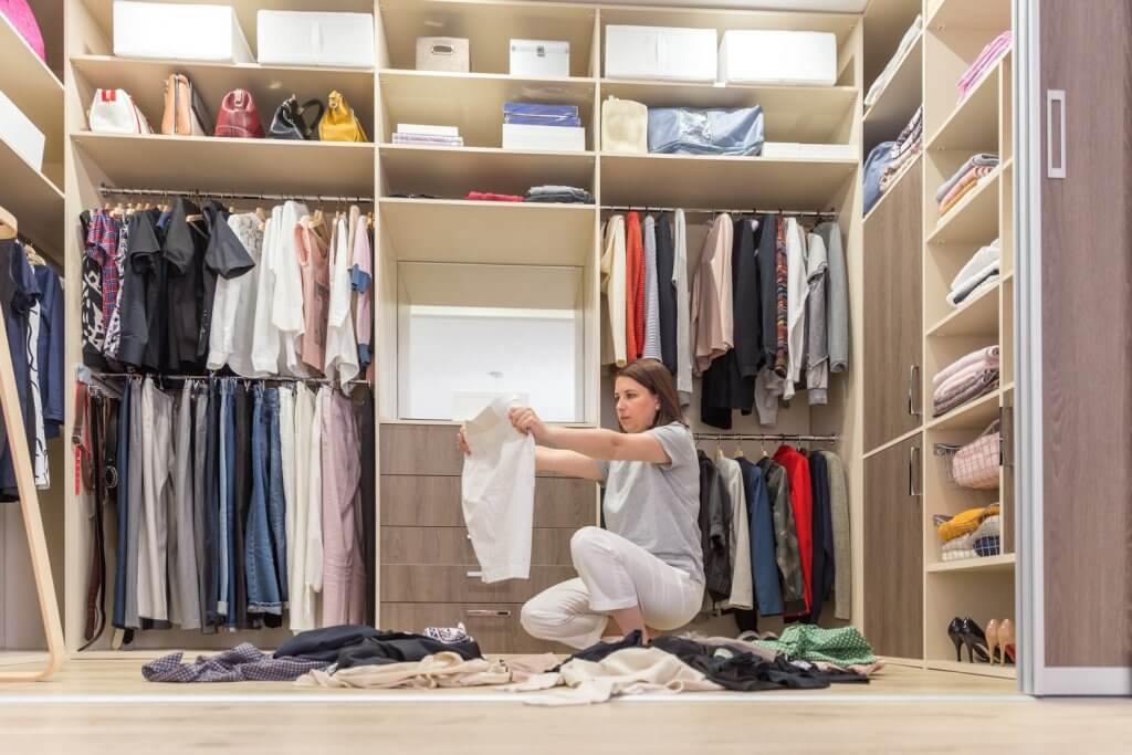 sorting clothes in closet