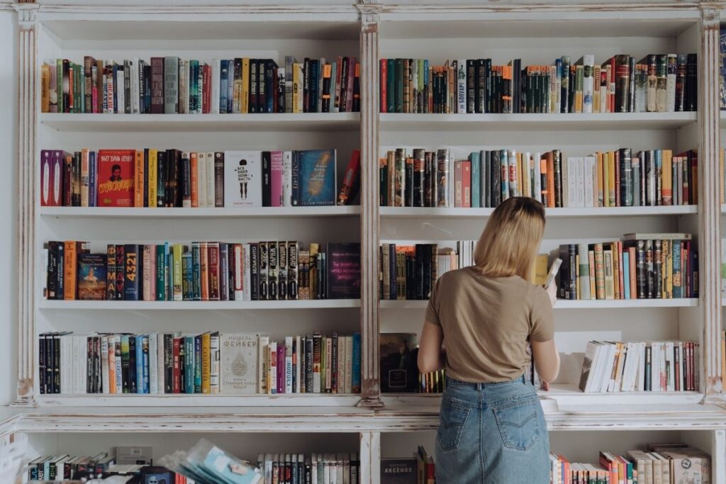 woman looking at book collection