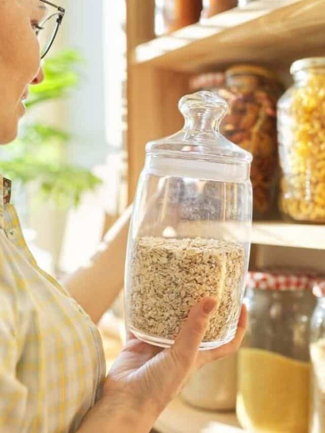 woman in a pantry holding glass jar of oats