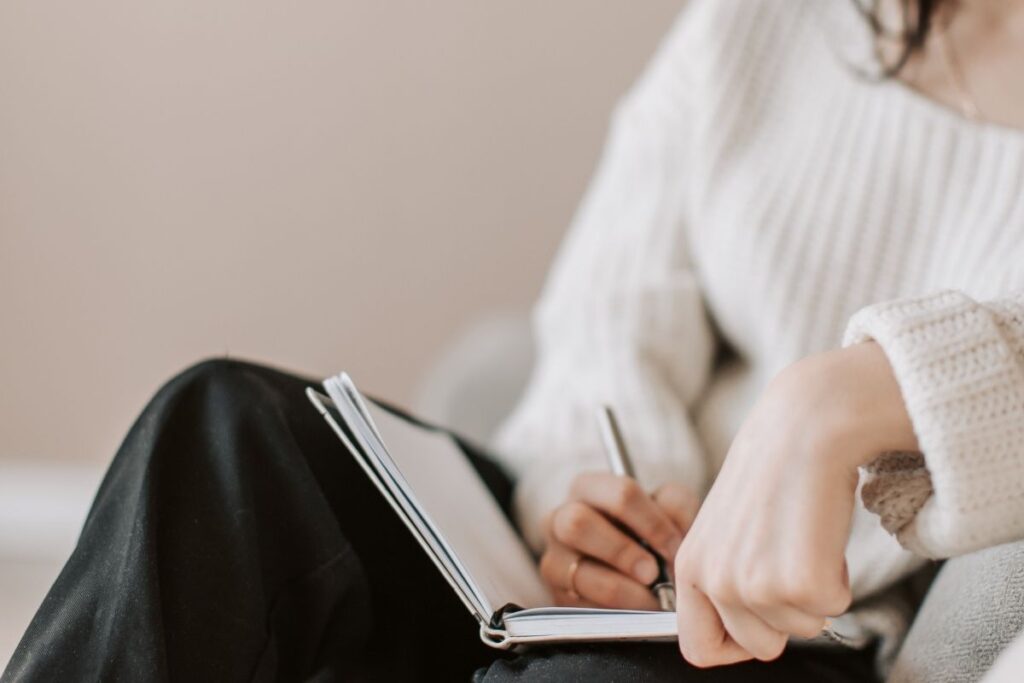 woman writing in notebook