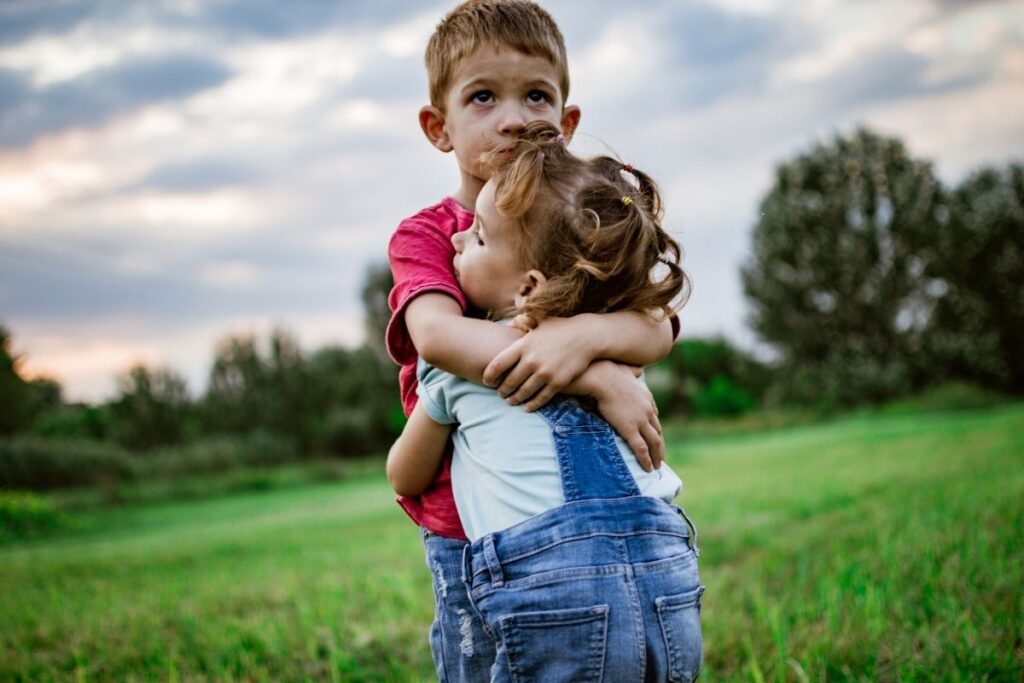 brother and sister hugging