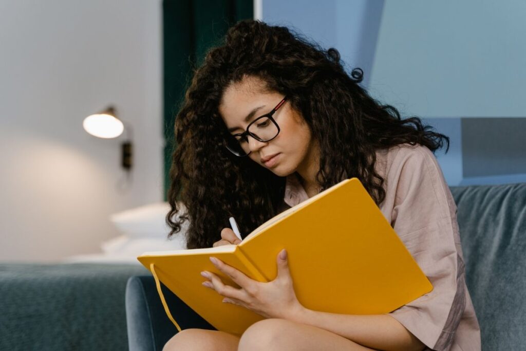 woman writing in book