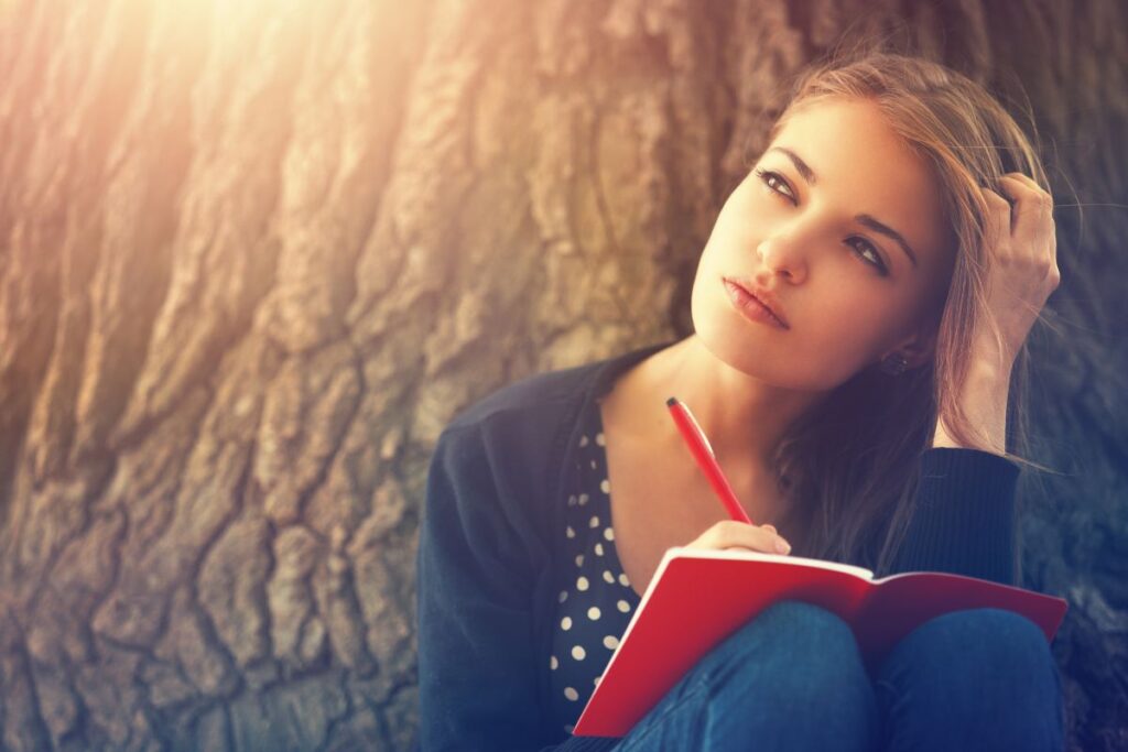 creative journal name ideas girl thinking and journaling