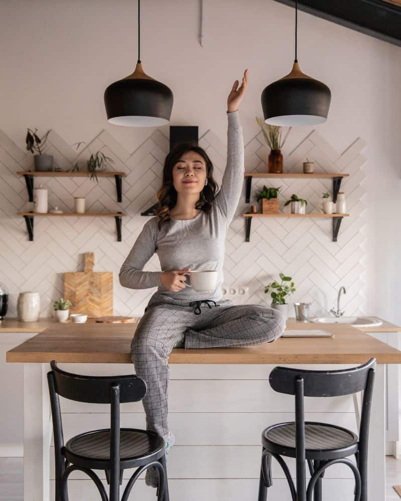 lady relaxing with coffee sitting on counter