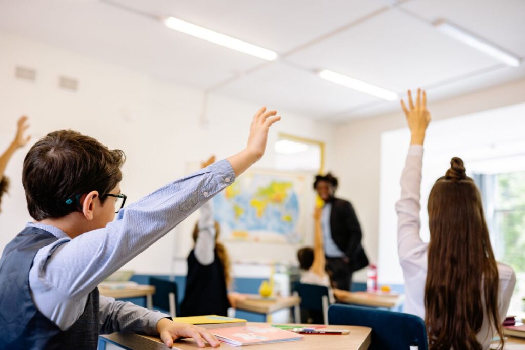 students raising their hands