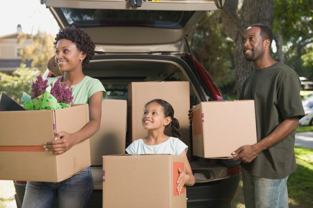 family holding moving boxes