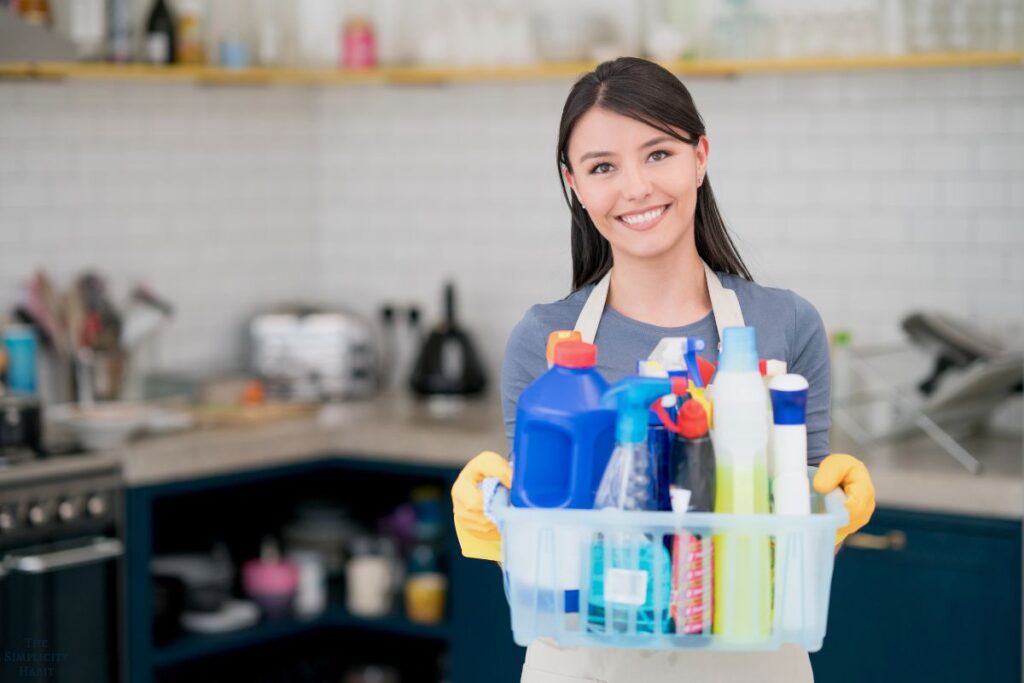 woman holding cleaning supplies