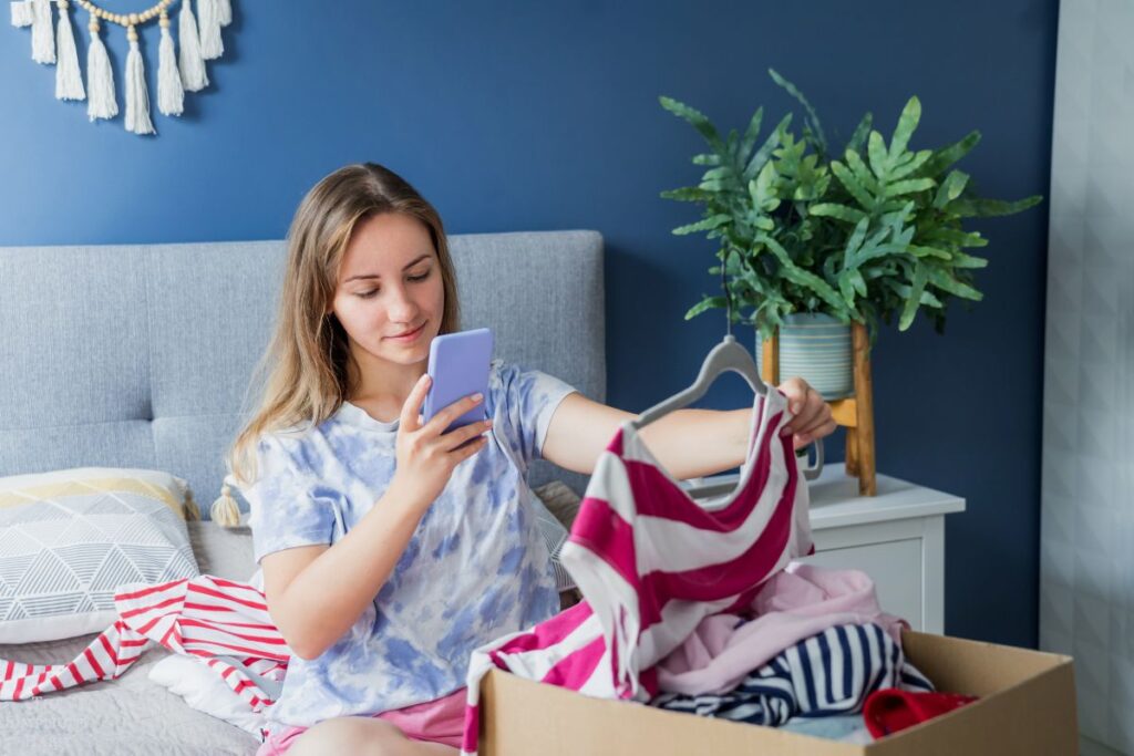 woman taking a picture of shirt to sell it