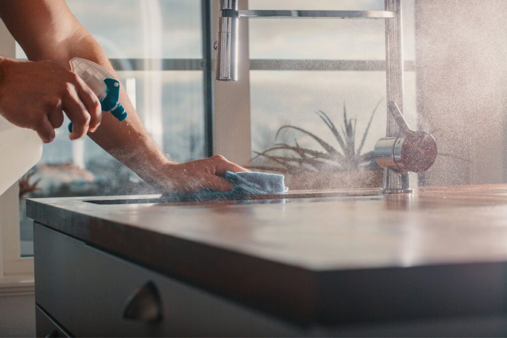 spraying cleaner on a countertop