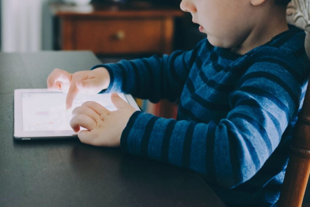 child playing on ipad