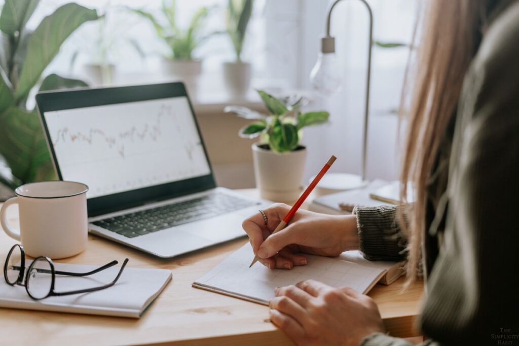 woman sitting at a desk writing