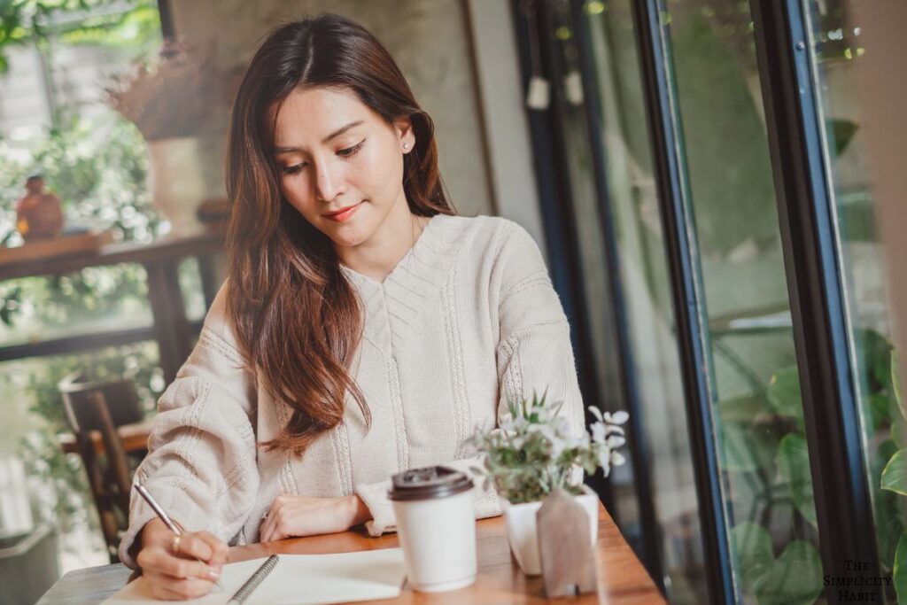 woman writing in a journal