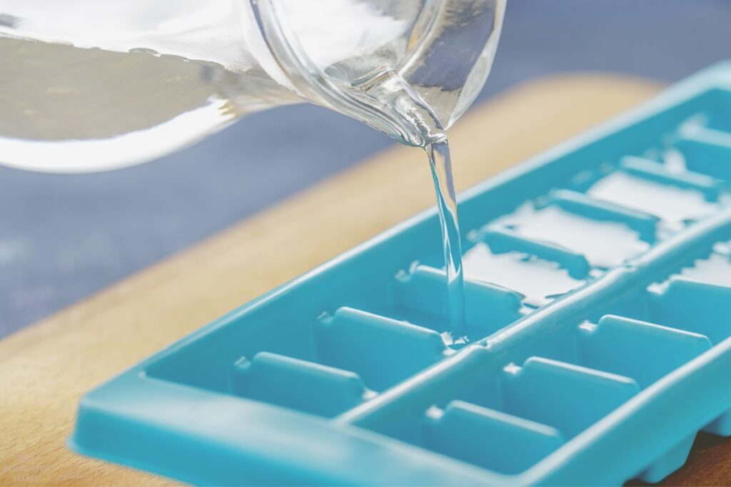pouring water into ice trays