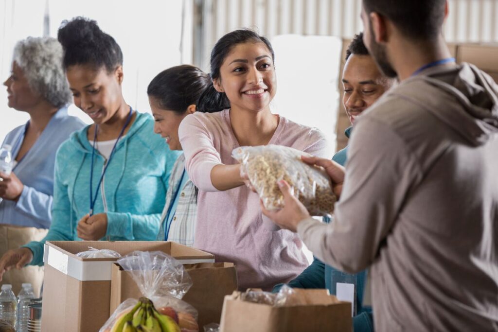 people volunteering and handing out food