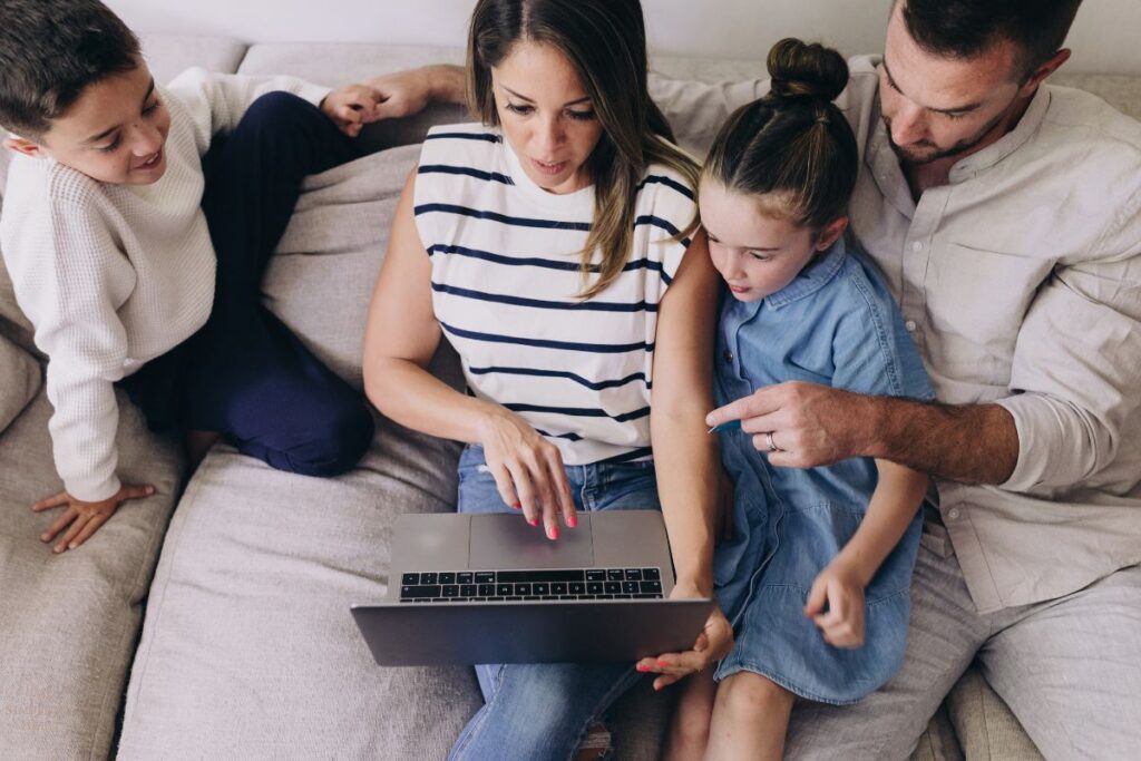 family looking at computer to budget their money