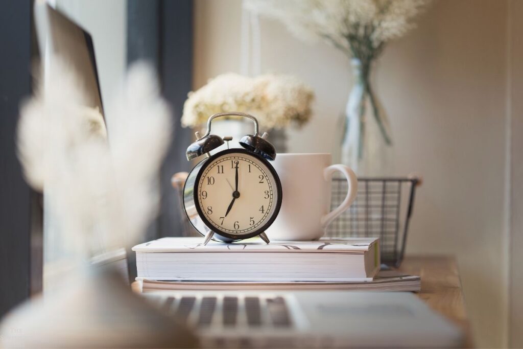 clock book and laptop