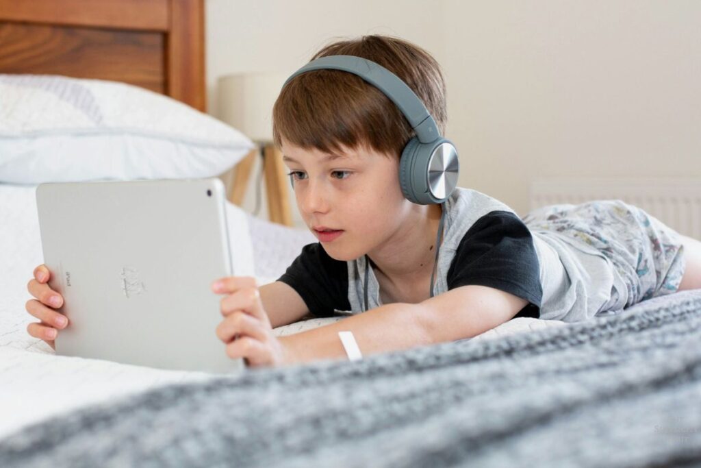 kid staring at a kindle