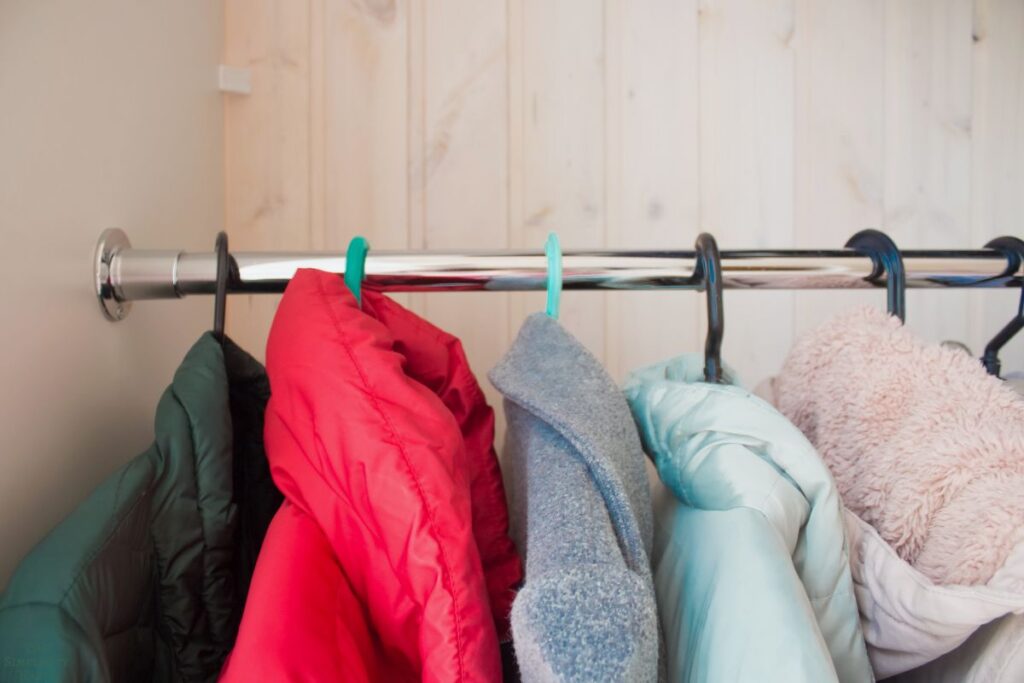 winter coats hanging in a closet