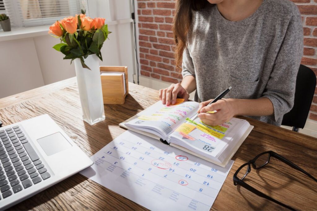 woman looking at cluttered appointment book