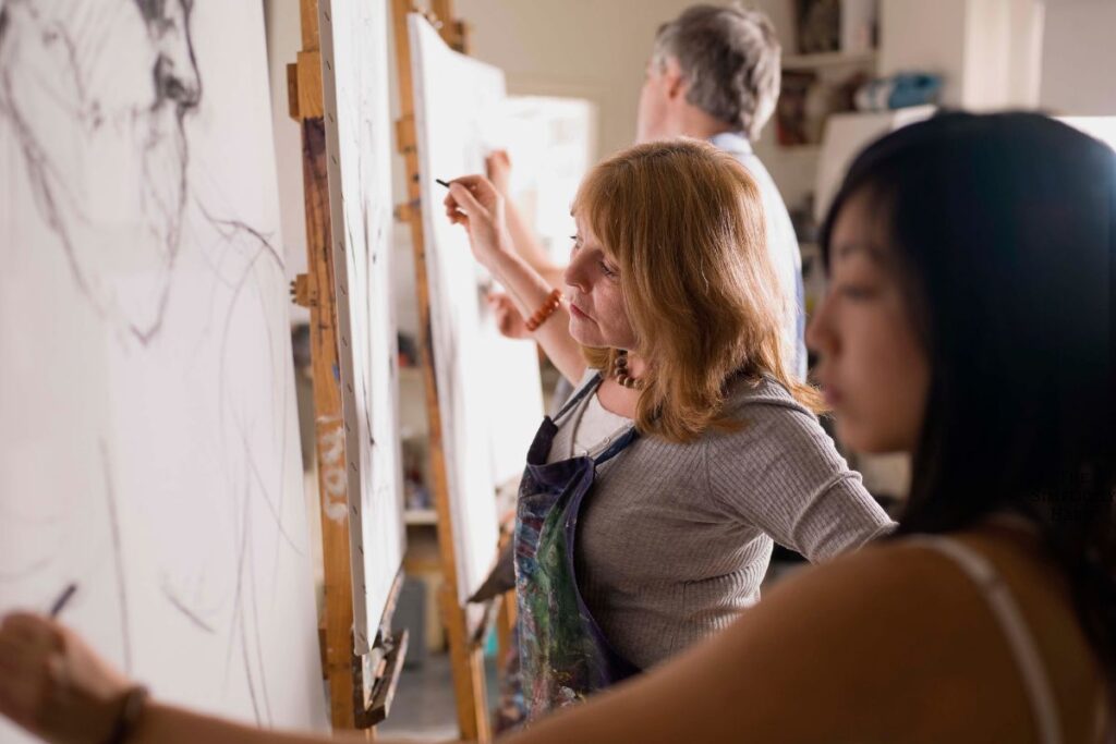 adults taking a drawing class